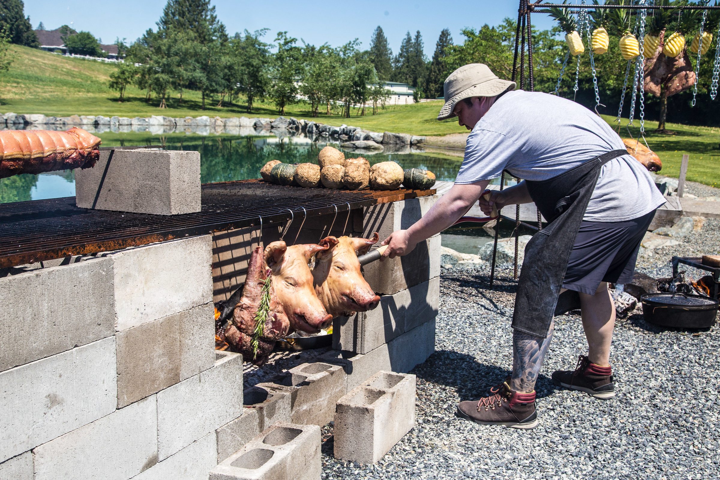 Chef Alex Chen tending a live-fire cinderblock grill