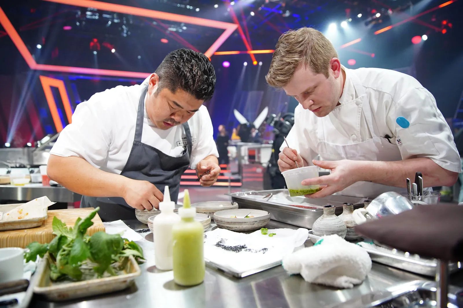 Chef Alex Chen plating alongside a fellow competitor on Iron Chef Canada