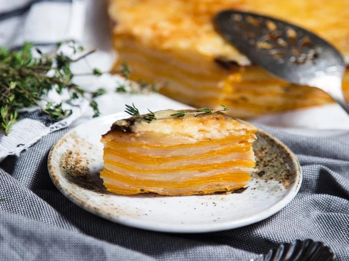 A sliced portion of butternut squash and Yukon gold potato gratin